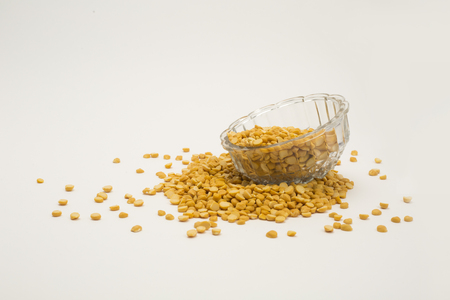Pile of yellow split peas chana dal in bowl isolated on white backgroundの写真素材