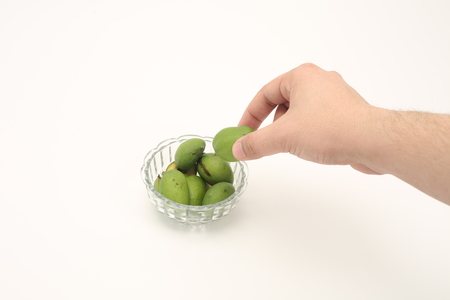 Green mango in glass bowl isolated on white background.の写真素材
