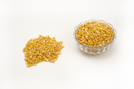 Pile of yellow split peas pulse with split peas in bowl. isolated on white backgroundの写真素材