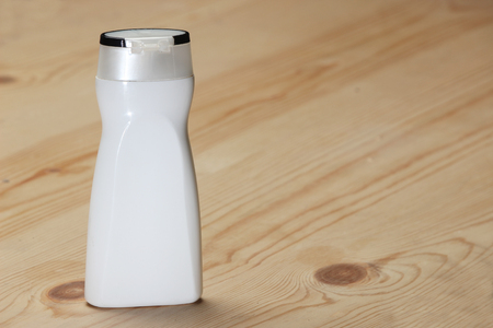 White  beauty products/cosmetics bottle on wooden background. Mock-up template ready for design.の写真素材