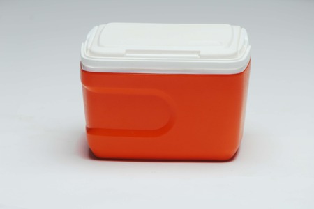 Handheld red refrigerator. Isolated on white background.の写真素材