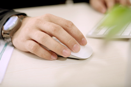 Man is using wireless mouse.