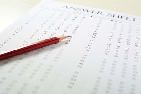 Picture of exam omr sheet and pencil. Isolated on white background.