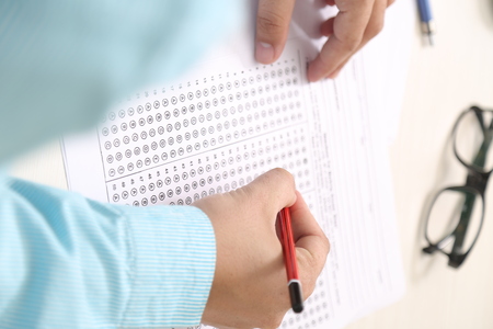 Picture of OMR sheet on the table. Man is holding pencil in hand.の写真素材