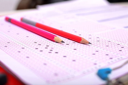Picture of two pencil on the OMR sheet and OMR sheet on the clipboard.の写真素材