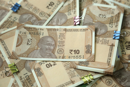 Many new Indian currency note with attached clip paper.