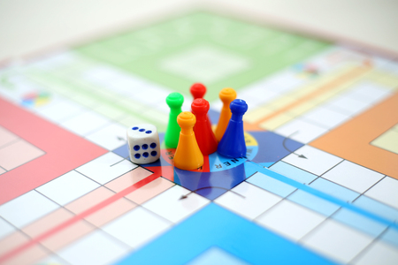 Picture of Dice and different colors tokens on the center ludo game.の写真素材