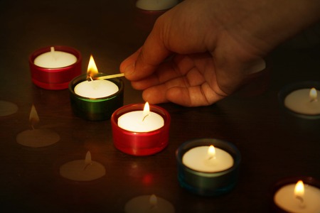 Man is lighting lit during Indian Diwali lamps.の写真素材
