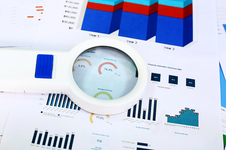 Portrait of financial graph paper and Magnifying glass.の写真素材