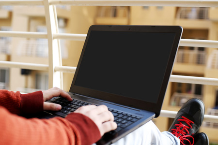 Boy is working on the laptop.