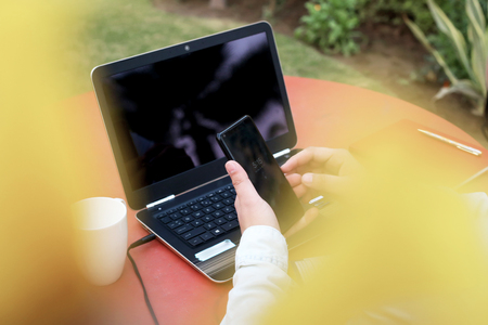 Young man is using phone in hand.の写真素材