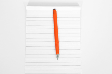 Empty notebook paper with pen. Isolated on the white background.の写真素材