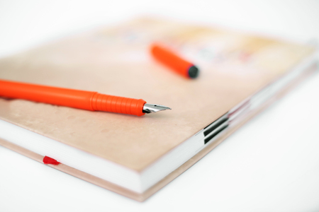 Picture of closed diary with pen. Isolated on the white background.の写真素材