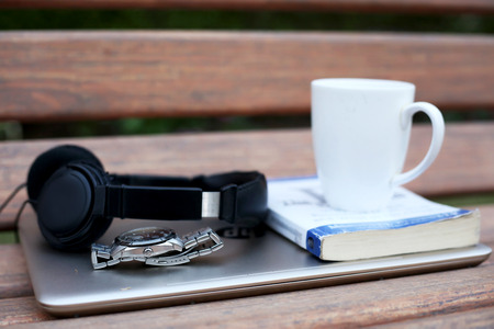 Picture of cup,book, wristwatch,headphone and laptop.の写真素材