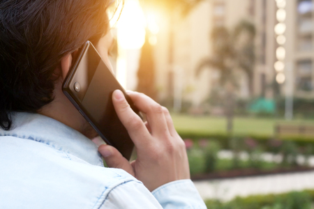 Young man is talking phone on the park.の写真素材