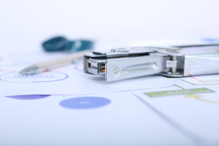 Picture of pen and stapler on the office paper.