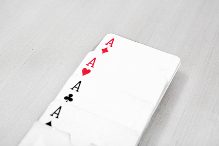 Picture of four aces poker playing card. Isolated on the grey background.