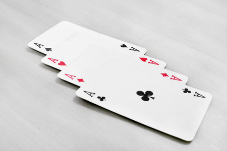 The combination of aces playing cards. Isolated on the grey background.