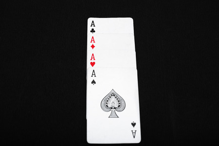 Portrait of four aces poker play card. Isolated on the black background.の写真素材