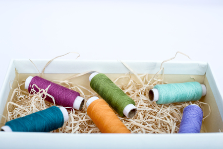 Colorful sewing thread in the box. Isolated on the white background.の写真素材