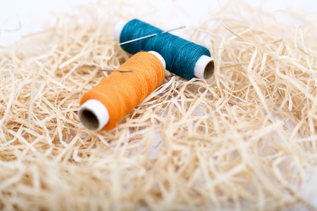 Picture of two thread with needle. Isolated on the white background.