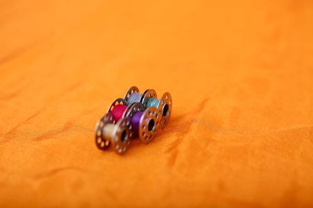 Picture of bobbins. Isolated on the yellow background.