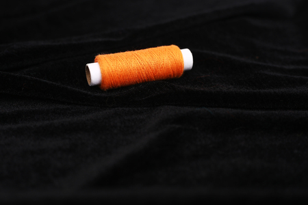 Picture of orange thread. Isolated on the black background.の写真素材