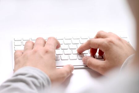 Picture of man typing with the keyboard. Isolated on white background.
