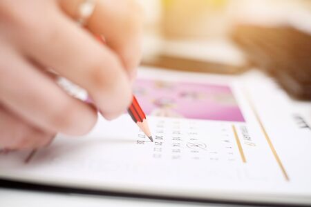 Picture of Man holding Calendar and marking on date. Isolated on white background.の写真素材