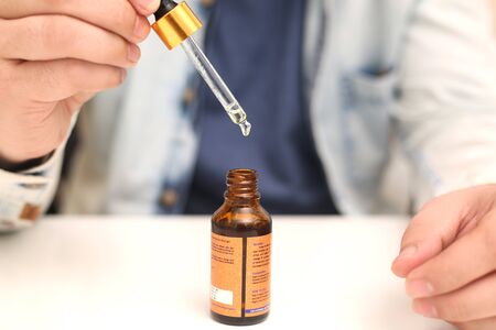 Picture of man drop medicine bottle holding in hand. Isolated on white background.