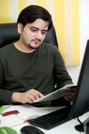Picture of a businessman working in the office. Isolated on a white background.の写真素材