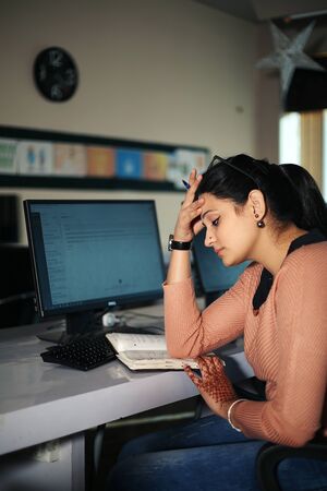 Young businesswoman sitting at desk working using computer, modern executive girl at the office.の写真素材