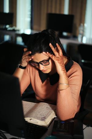 Young businesswoman sitting at desk working using computer, modern executive girl at the office.の写真素材