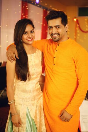 Indian couple is Celebrating Diwali. Isolated on decorative background.の写真素材