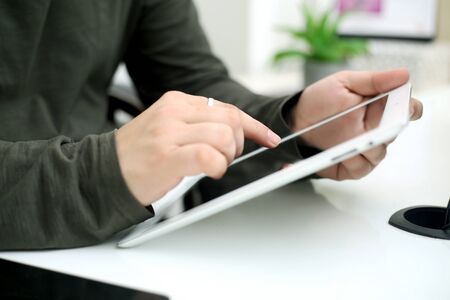 Picture of businessman working in office with tablet. Isolated on white background.の写真素材