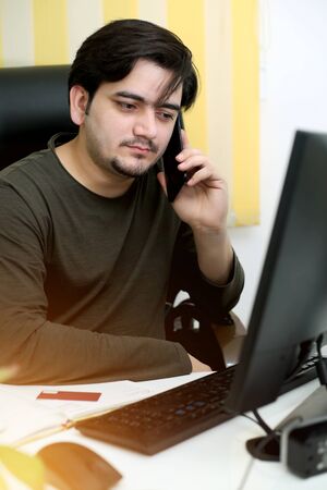 Picture of businessman working in office. Isolated on white background.の写真素材