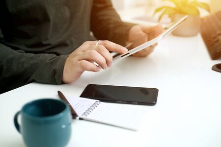 Picture of businessman working in office with tablet. Isolated on white background.の写真素材