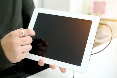 Picture of businessman working in office with tablet. Isolated on white background.の写真素材