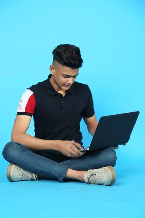 Picture of a smart boy with a laptop. Isolated on white background.の写真素材