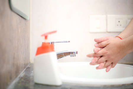 Wash hands with liquid soap gently to stay prevent from backterias and infectionsの写真素材