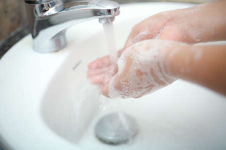 Wash hands with liquid soap gently to stay prevent from backterias and infectionsの写真素材