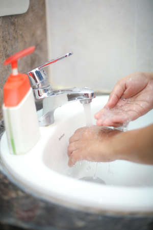 Wash hands with liquid soap gently to stay prevent from backterias and infectionsの写真素材