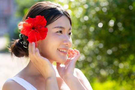 Summer Beauty Image - Red Hibiscus and Black Haired Womanの写真素材