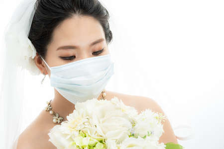 a woman in a masked wedding dressの写真素材