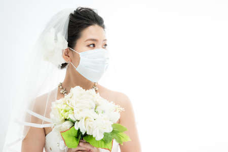 a woman in a masked wedding dressの写真素材