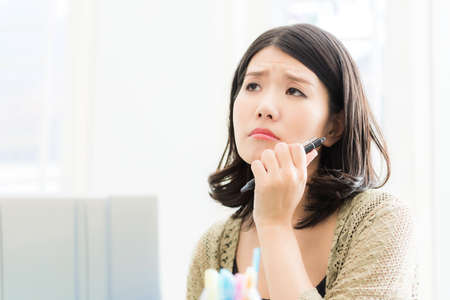 A Japanese woman who suffers from a work place with a personal computerの写真素材