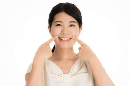 Young Japanese woman smiling with teethの写真素材