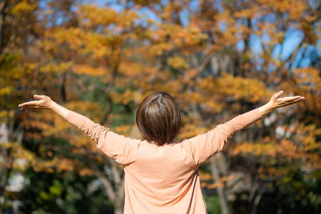 Woman relaxing in autumn sceneryの写真素材
