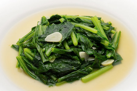 sautÃ©ed garlic and spinach on a white background.