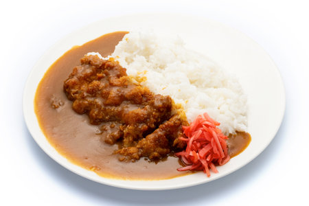 Japanese curry rice with fried pork on white plate isolated over white backgroundの写真素材